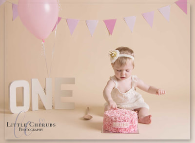 sweet baby in crown picking at birthday cake first photo shoot cake smash photographer little cherubs march cambridgeshire